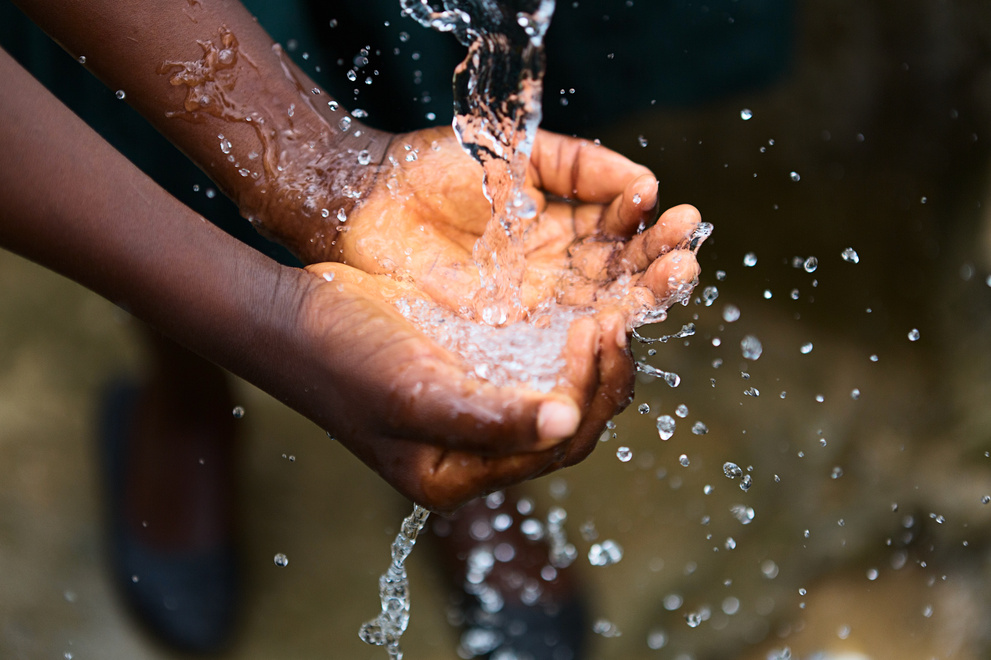 Hands of poor child - scoop drinking water, Africa