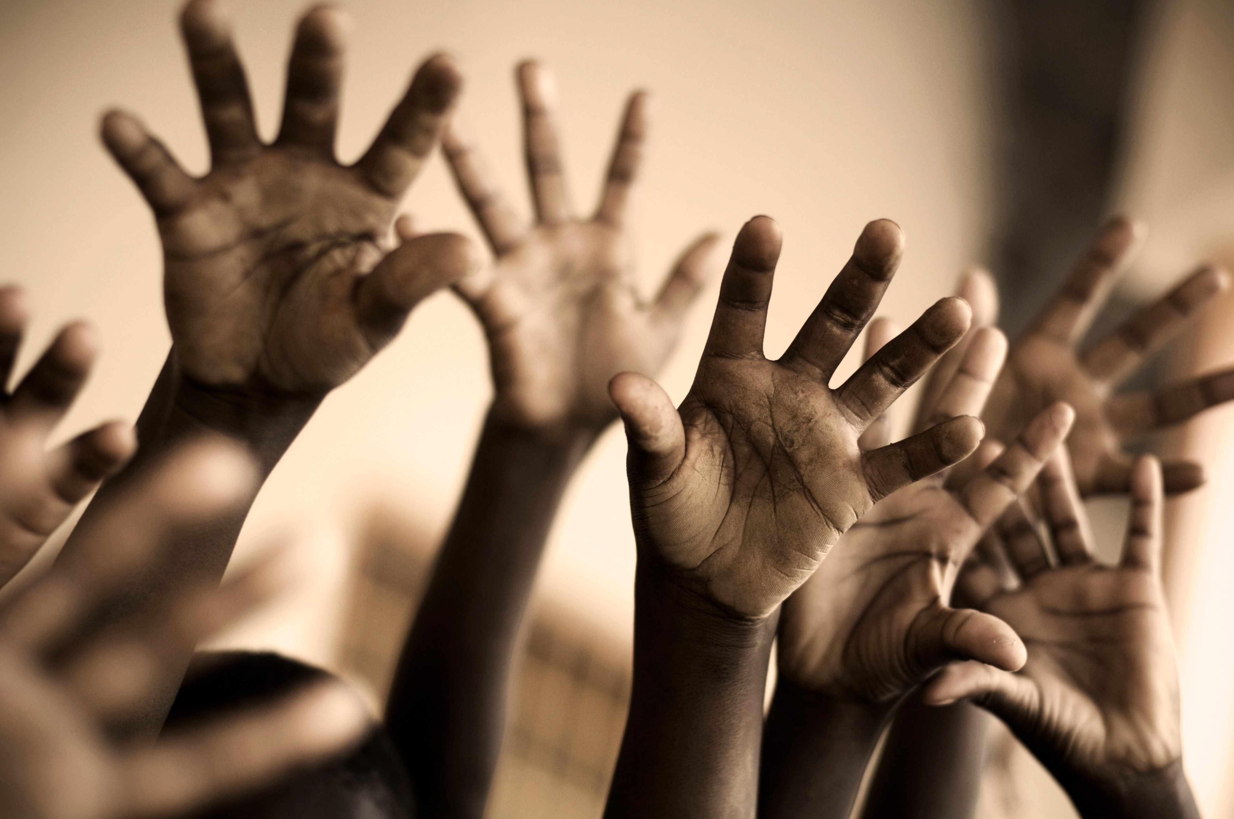 Raised Hands of African School Children